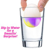 Color-changing squishy egg in a clear cup with hands above