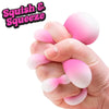 Squishy color-changing egg toy held in hands, pink and white
